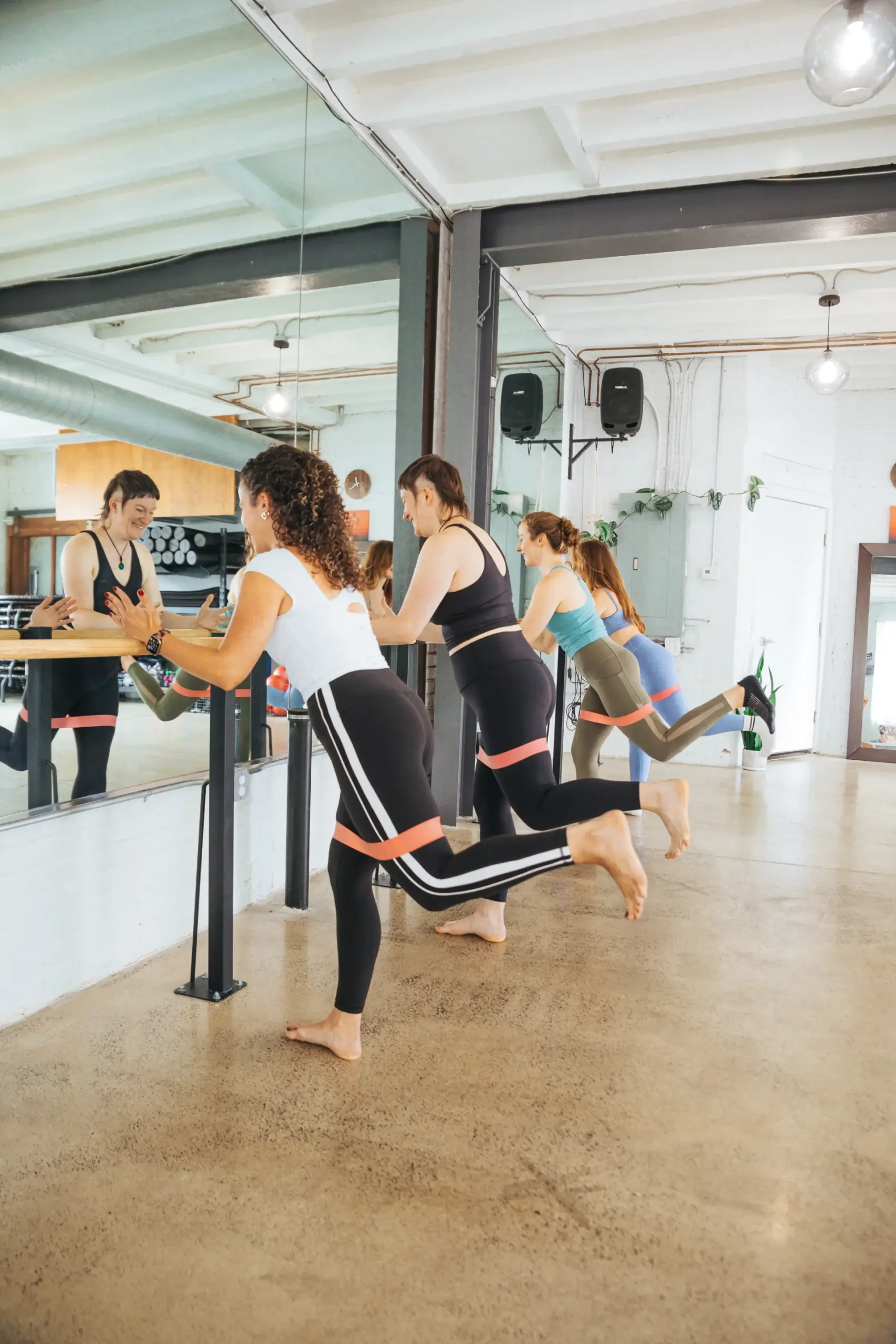 A Tuck Barre class at the barre using resistance bands, Northern Liberties studio